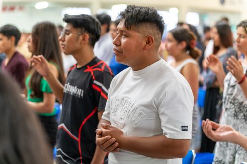 Free Group of young adults praying together indoors in Ciudad de México, showcasing community and spirituality. Stock Photo