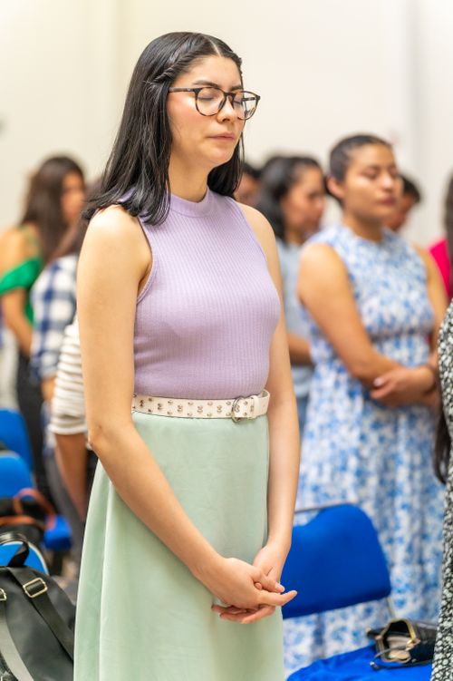 Free A young woman praying with others in a church in Ciudad de México, capturing a moment of spirituality. Stock Photo