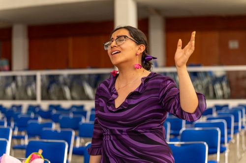 Free A woman stands praying indoors in Ciudad de México, expressing devotion with her raised hand. Stock Photo