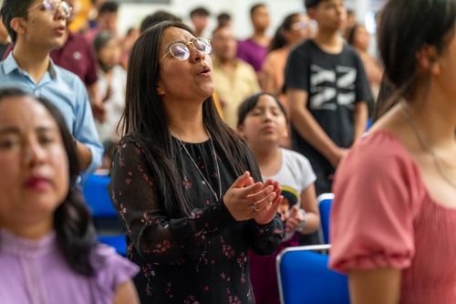 Free A diverse congregation in Ciudad de México engaged in prayer during a church service. Stock Photo