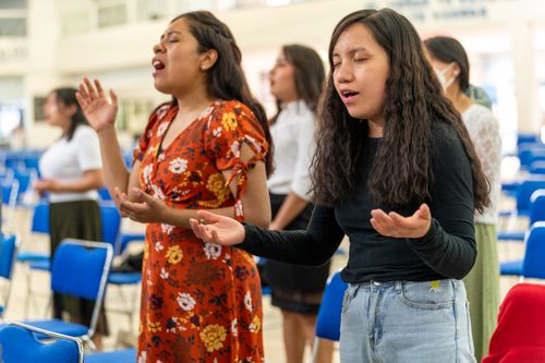 Free Women participating in a religious service, praying with eyes closed in Mexico City. Stock Photo