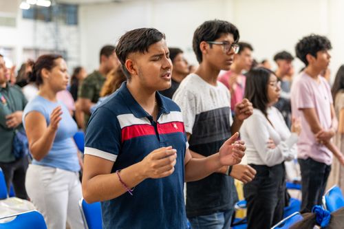 Free Young adults praying during a religious gathering in Ciudad de México, México. Stock Photo