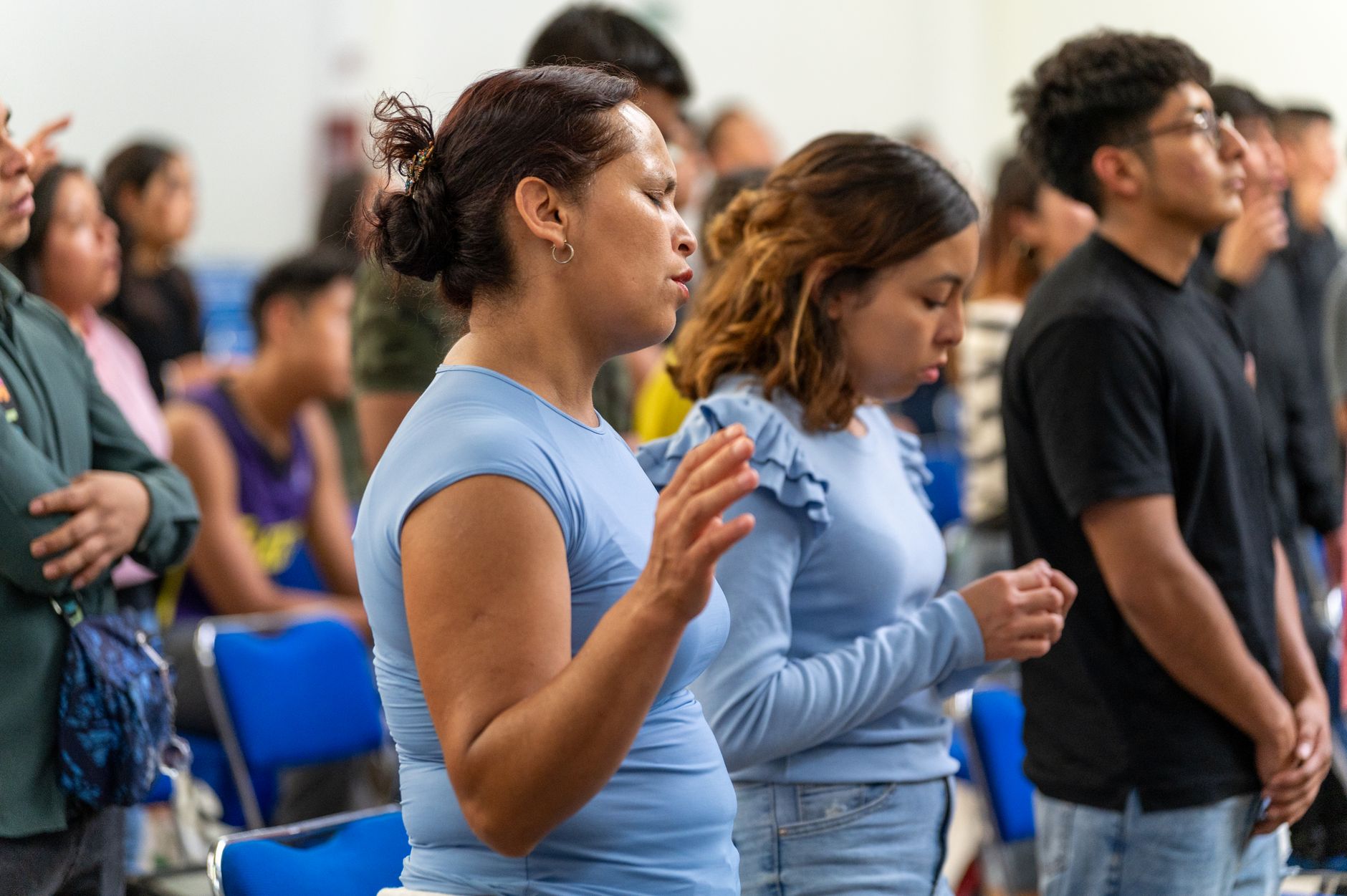 People engaged in a prayer session inside a church in Ciudad de México, expressing spirituality and community.