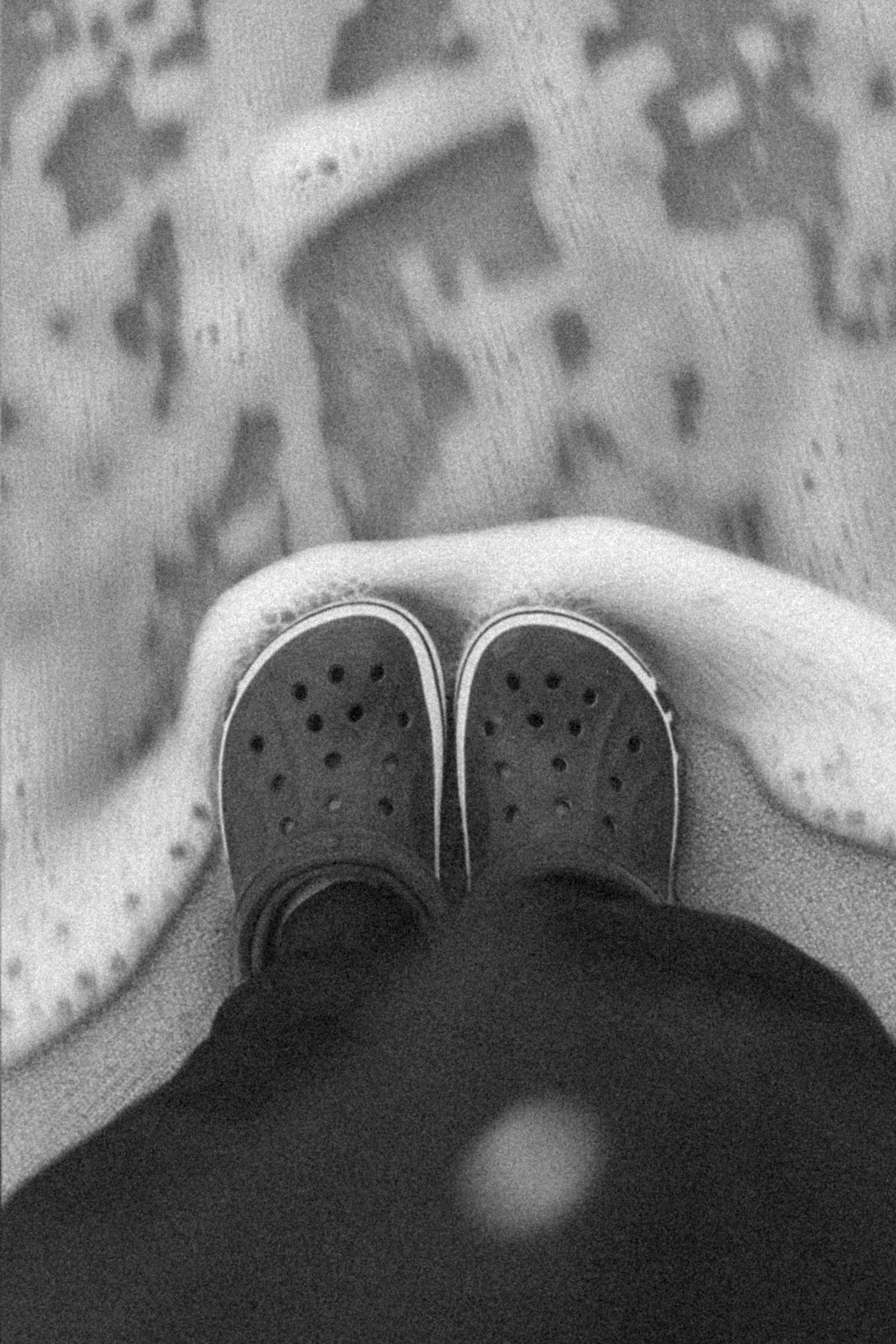 A Person in Crocks Standing on the Beach · Free Stock Photo