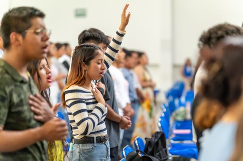 Free Group of worshippers standing and singing during a church service in Ciudad de México, México. Stock Photo