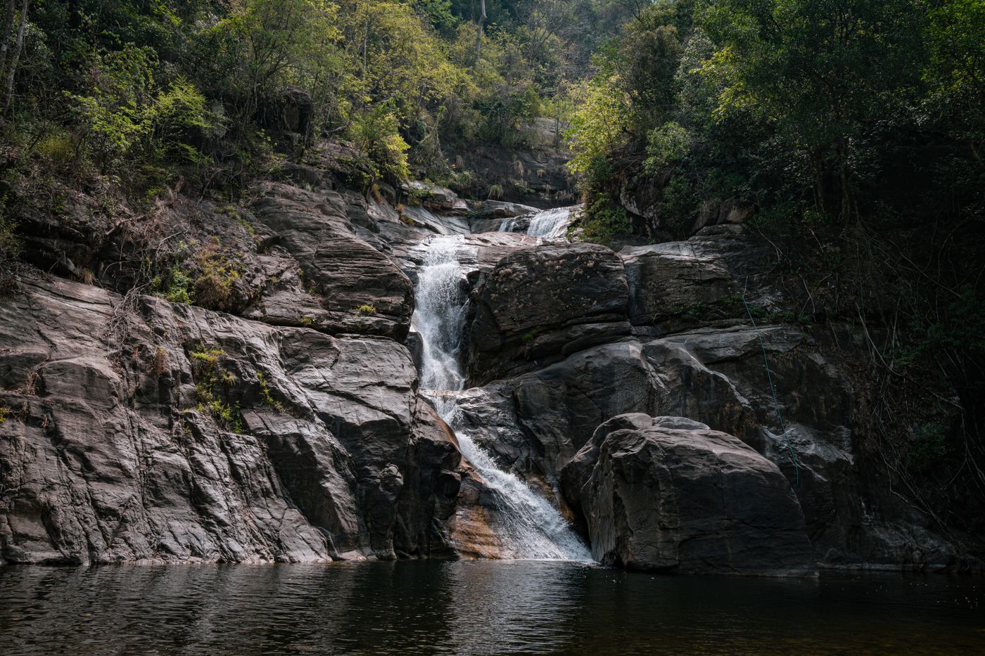 The main fall pouring over forest rocks