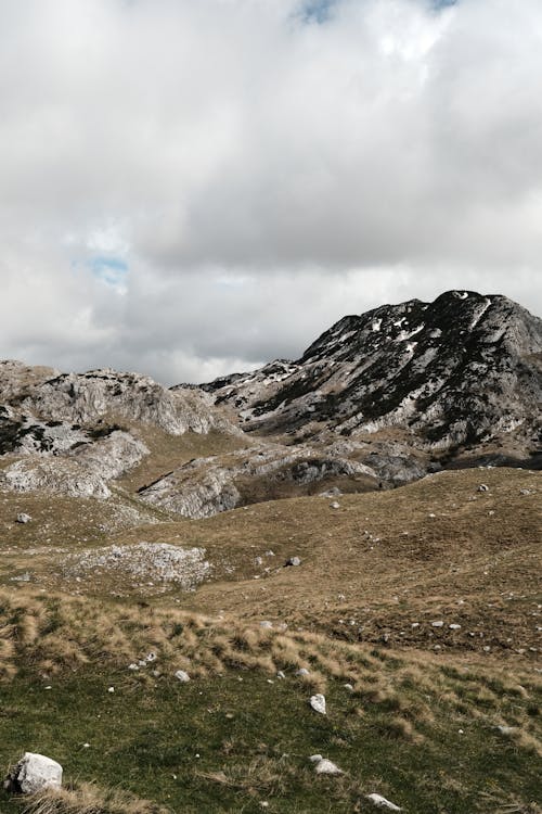 A mountain range with grass and rocks