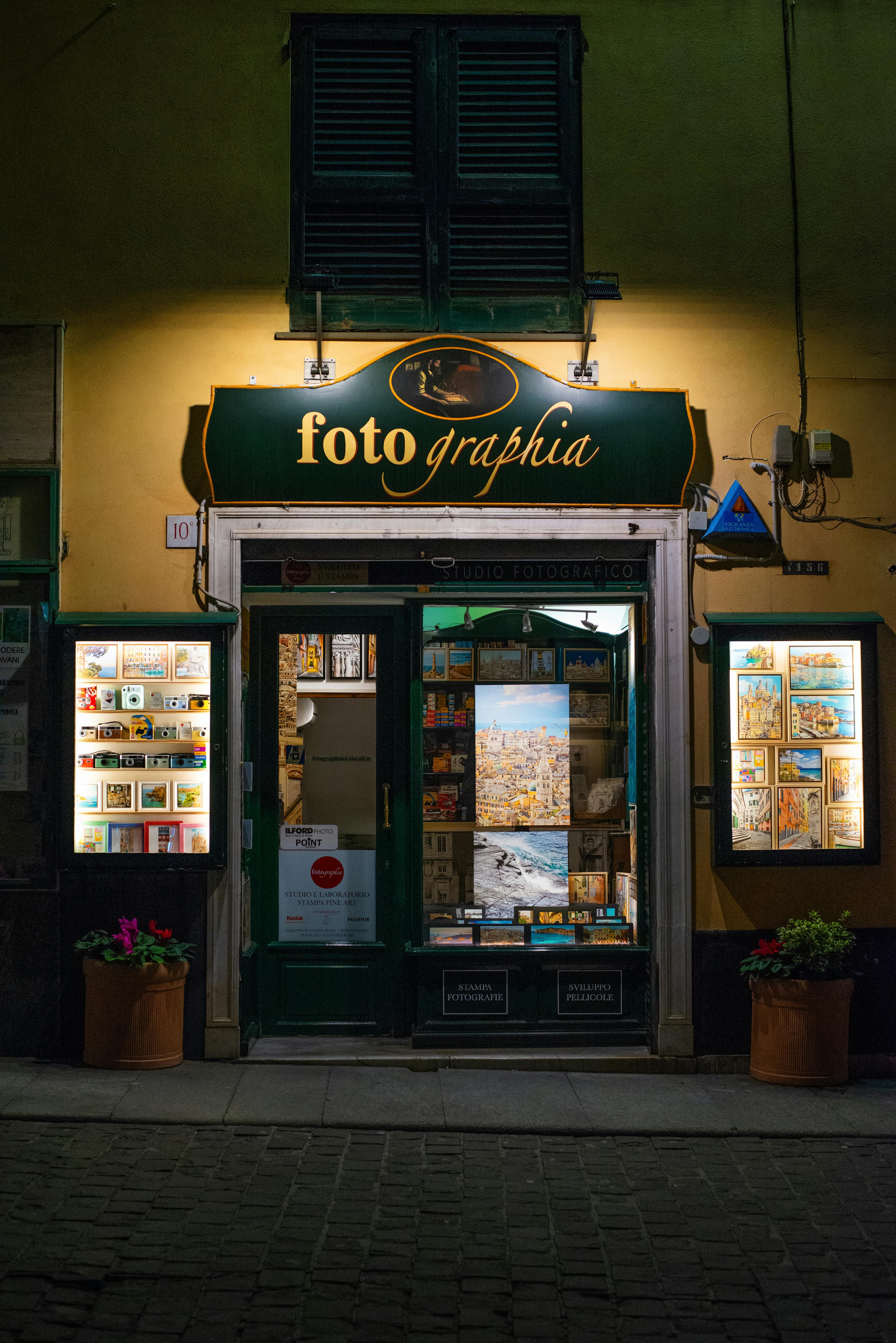 A quaint store entrance in Genoa, Italy, beautifully illuminated at night.