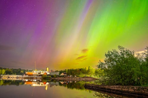 The aurora bore is seen over a river and a dock