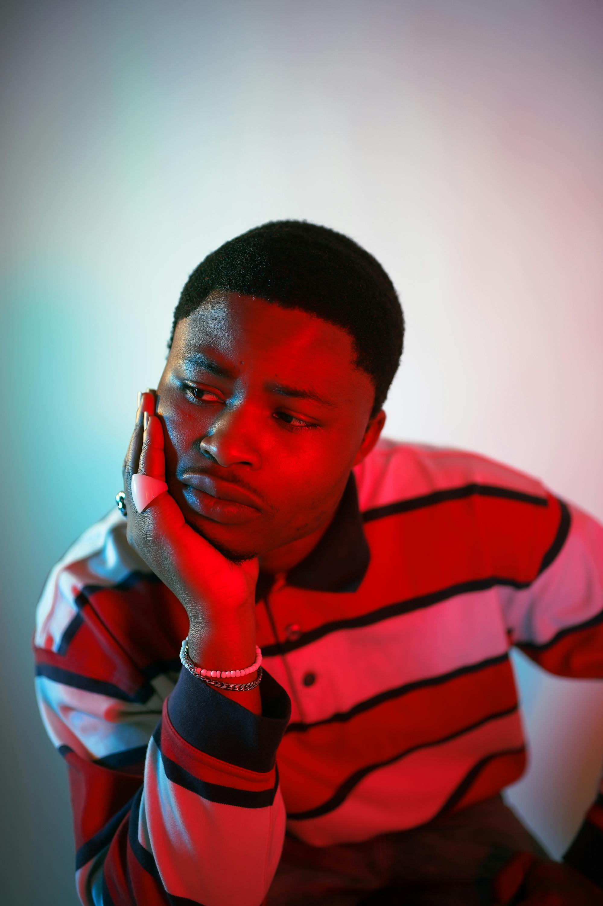 Moody portrait of a man in red lighting, Birmingham studio.