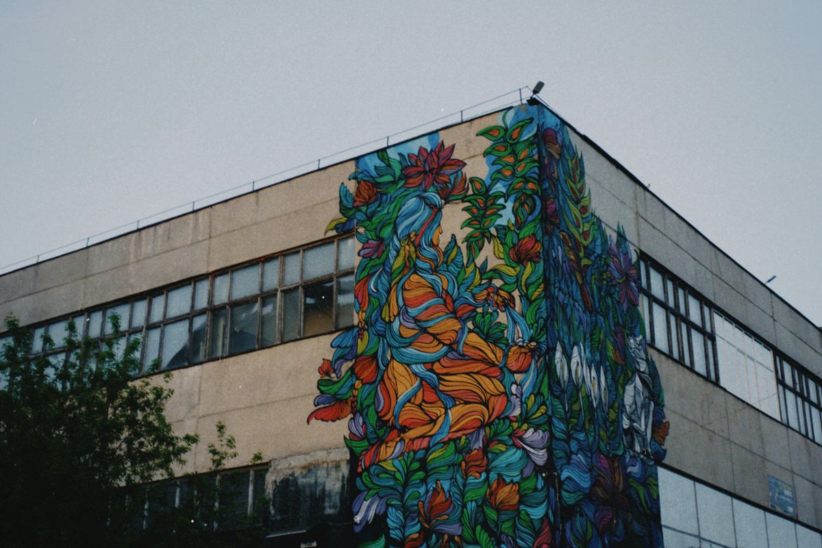 Street art mural painted across an industrial building facade — photo by Margarita on Pexels