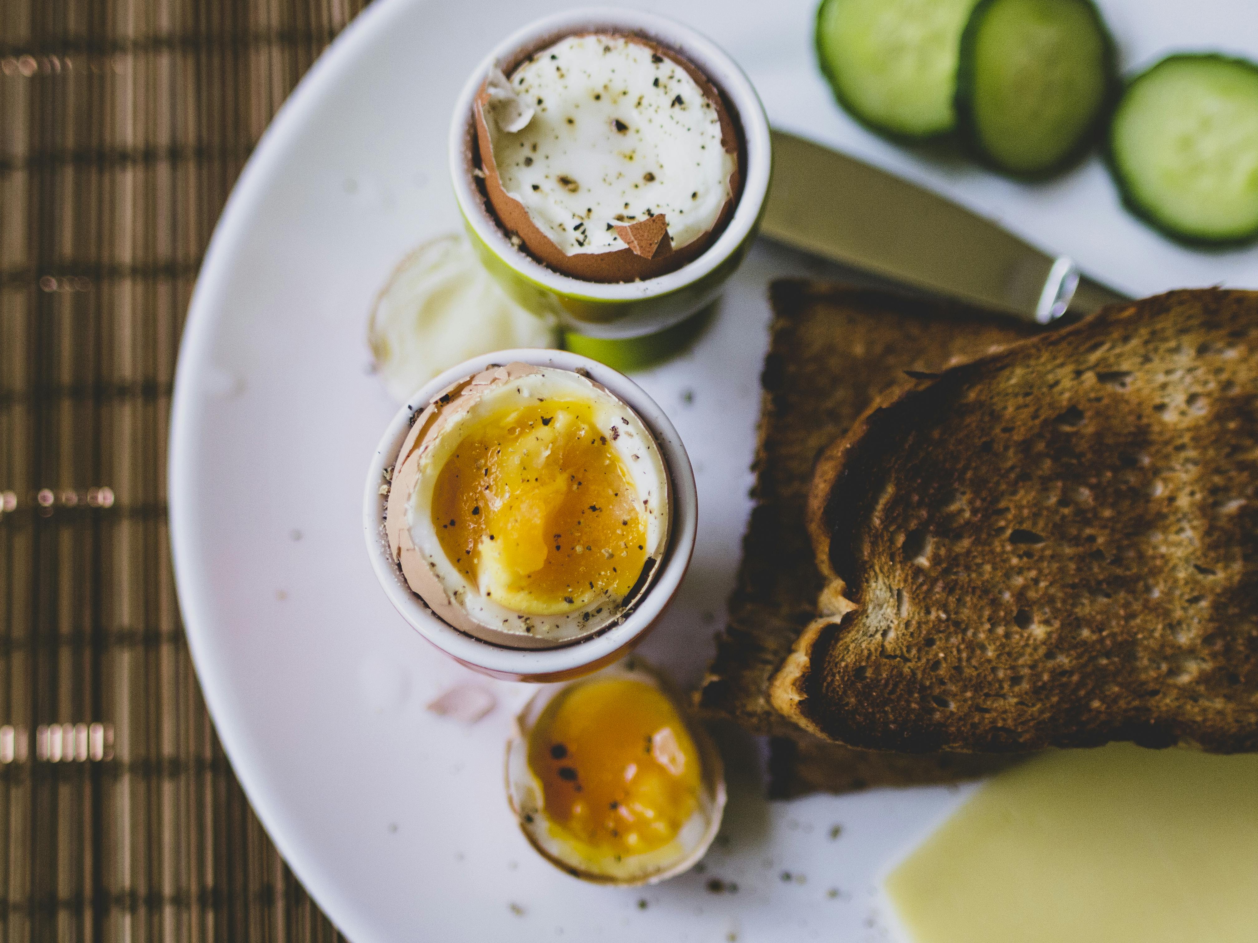 Foods on Plate Topped With egg cups with boiled eggs \u00b7 Free Stock Photo