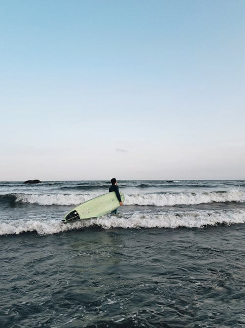 Person Holding Surf Board