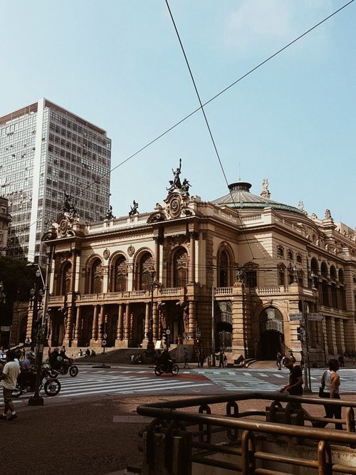 Free The iconic São Paulo Municipal Theater bustling with urban life on a sunny day. Stock Photo