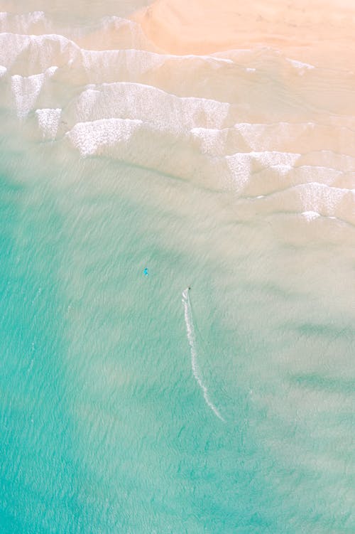 Aerial view of a surfer in the ocean
