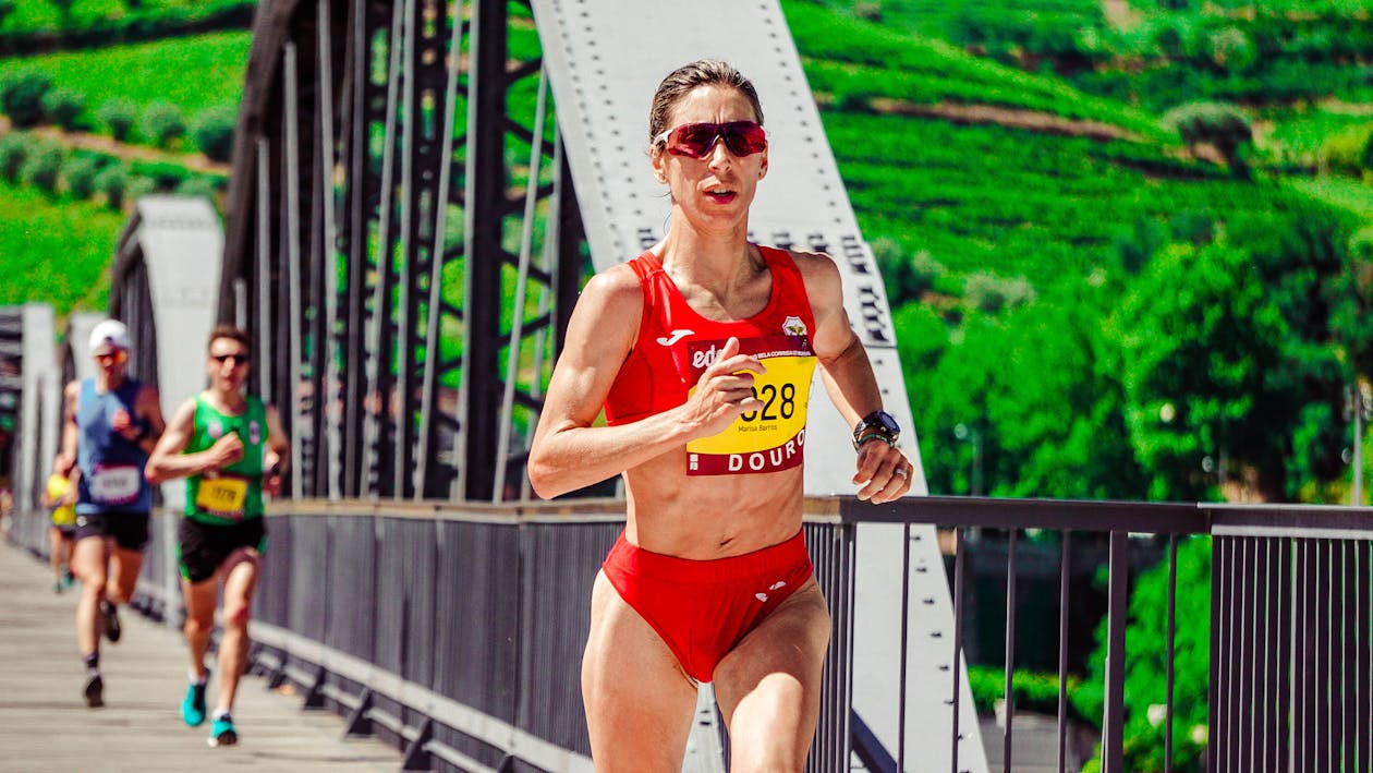 Free Woman Running on Bridge Stock Photo