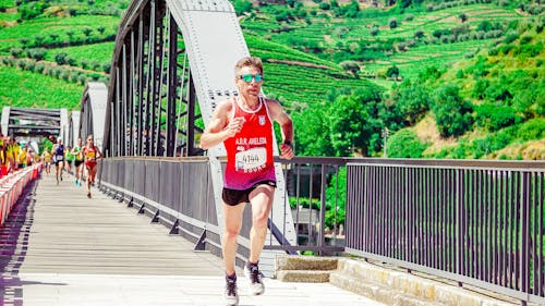 Male Runner Running on a Concrete Bridge