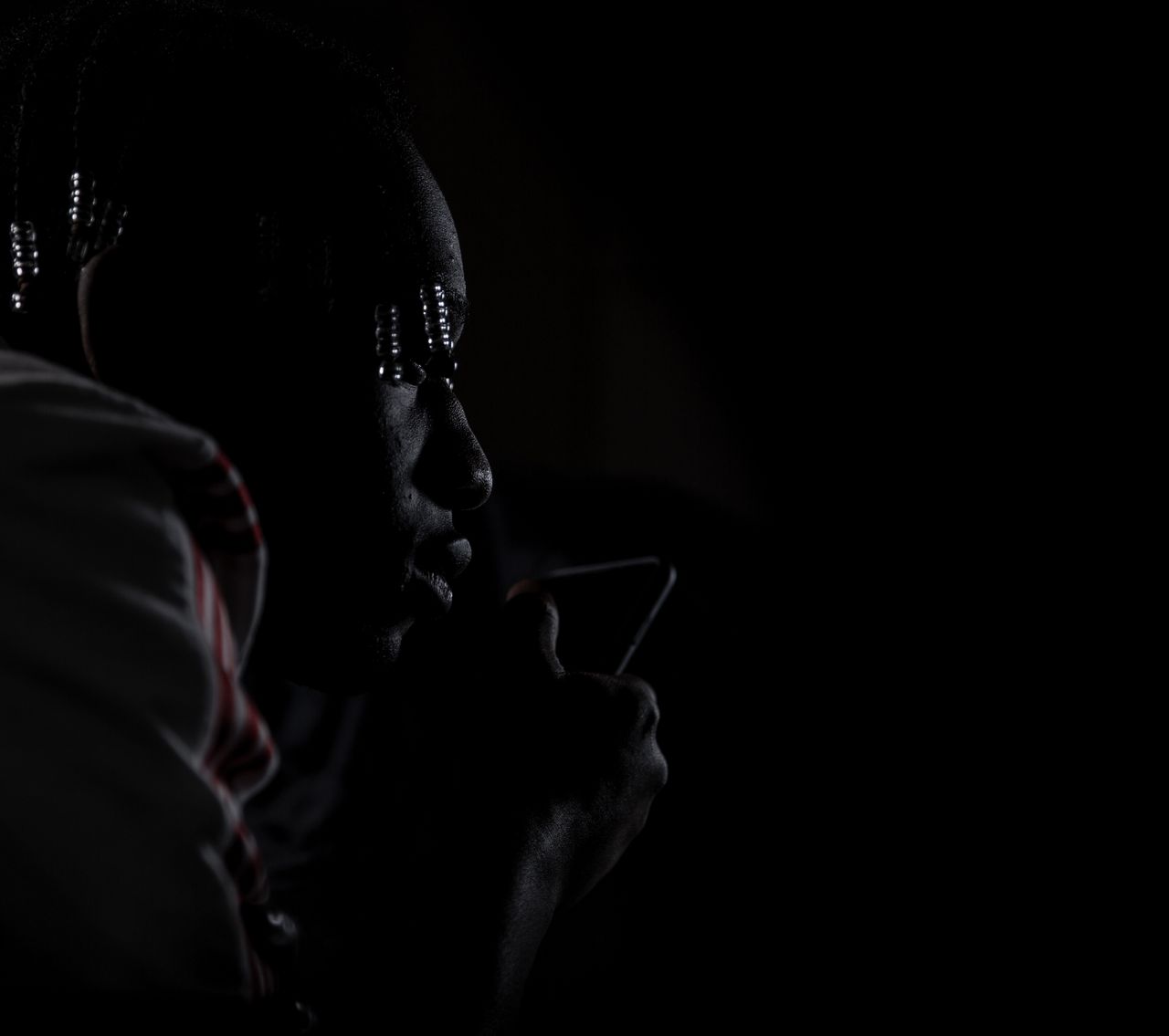 a striking close up portrait of a man in low light showcasing deep con