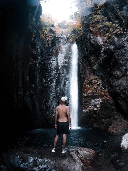 Free Unknown Person Standing Near Body of Water Stock Photo