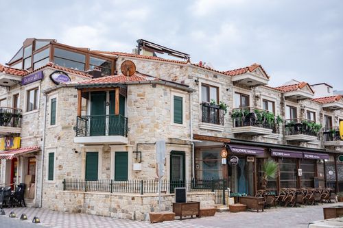 Free Beautiful stone townhouses with balconies in Foça, İzmir, Turkey. Stock Photo