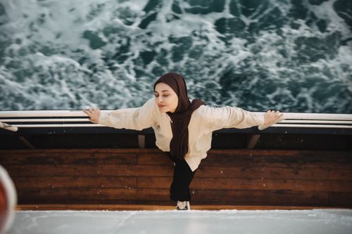 Free A woman with eyes closed enjoys the ocean breeze on a ferry in Adalar, İstanbul, Türkiye. Stock Photo
