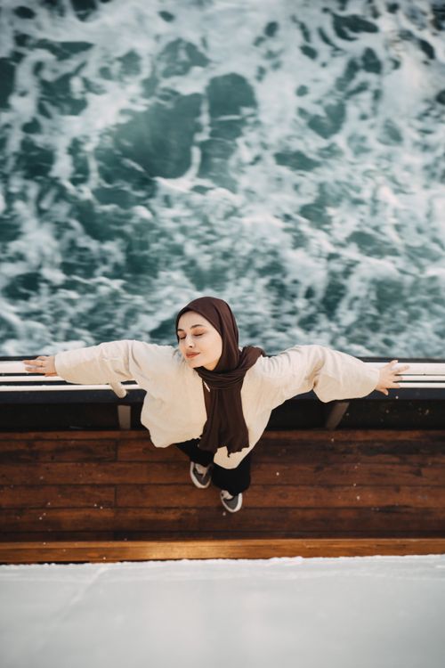 Free A serene moment of a woman with eyes closed enjoying the breeze on a ferry in Istanbul. Stock Photo