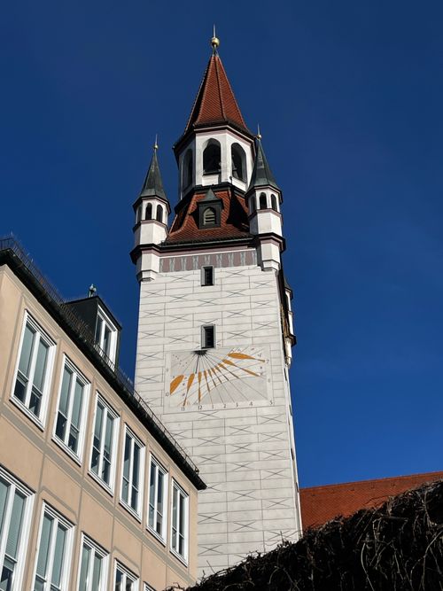 Free Old Town Hall's iconic tower with sun clock against clear blue sky in Munich, Germany. Stock Photo