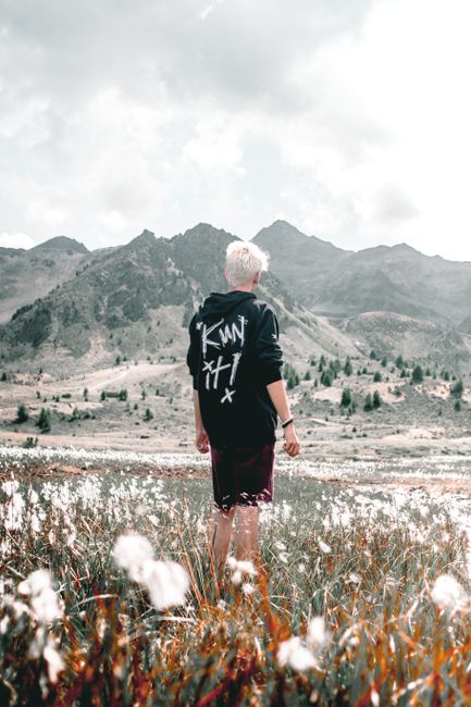 A young man examines the scenic Bormio landscape in the Lombardy region of Italy.