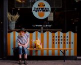 Man Sits Outside Herman ze German Store
