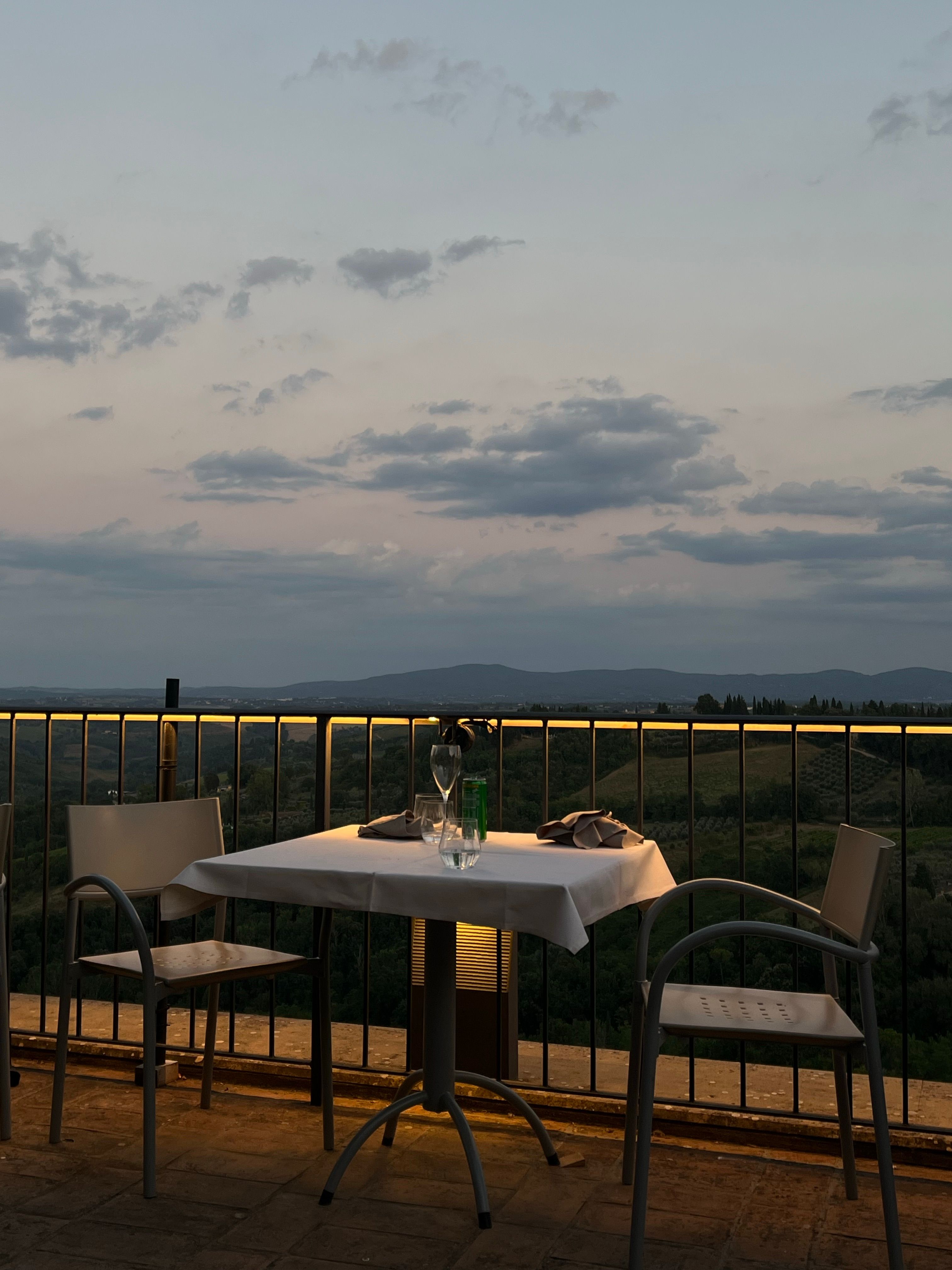 A Table with Glasses on a Terrace with a Scenic View · Free Stock Photo