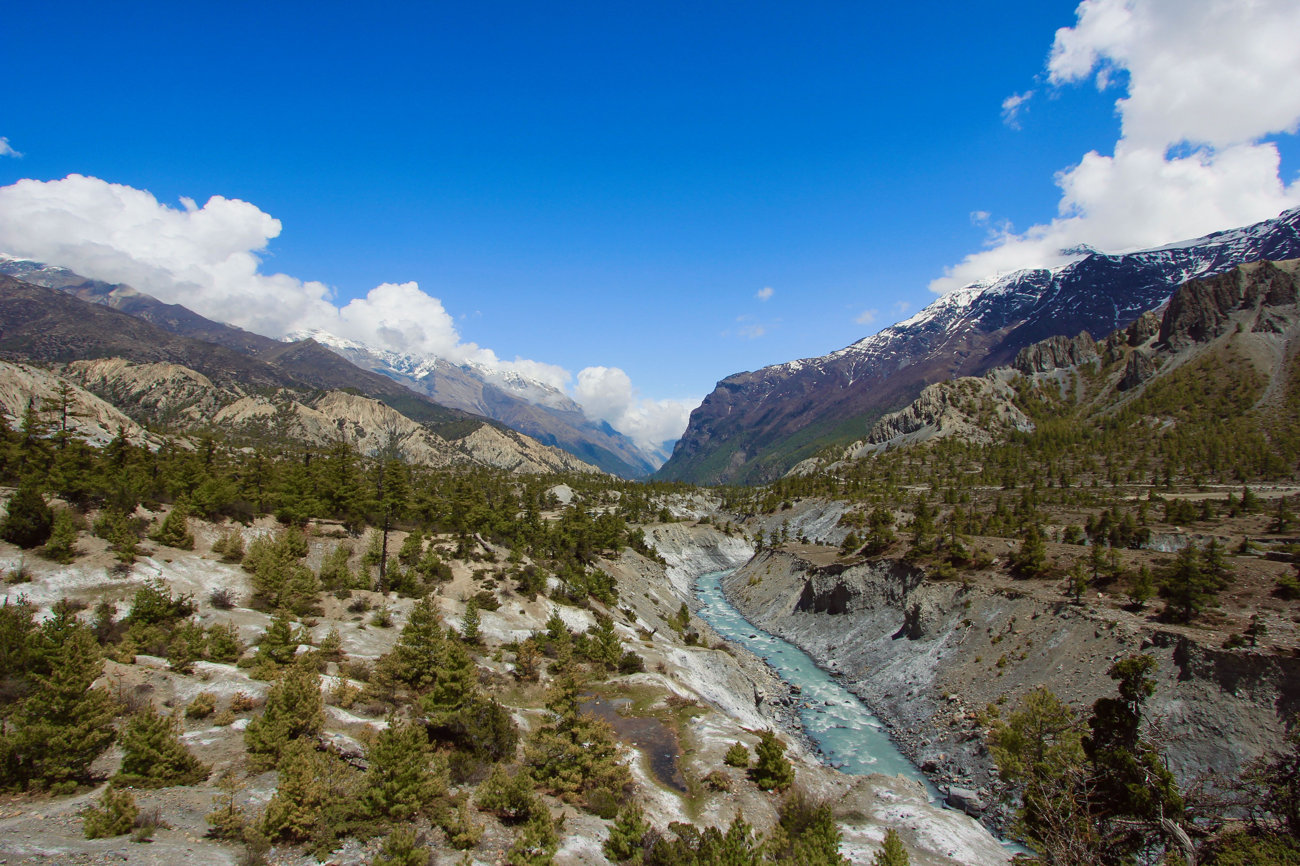 A glacial river journeys journeys through the majestic mountains of ...