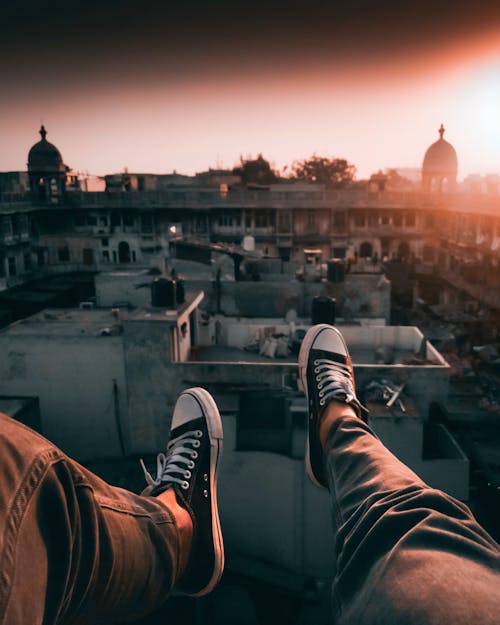 Photo of Person Wearing Jeans and Sneakers