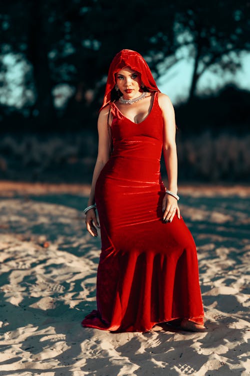 Woman in Red Dress and Veil on Beach