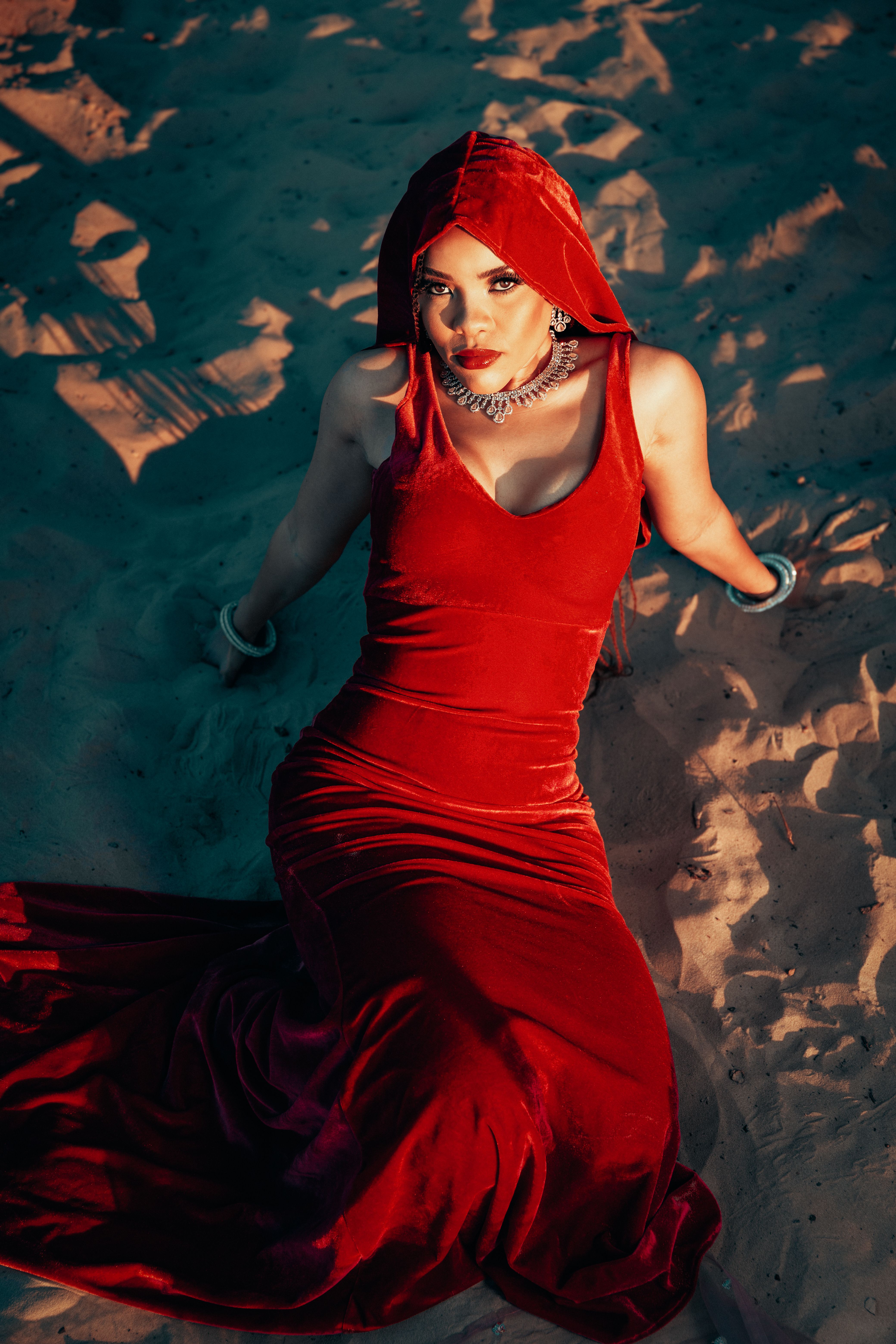 Woman Sitting in Red Dress on Sand · Free Stock Photo