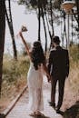 Photo of Couple Walking on Paved Pathway