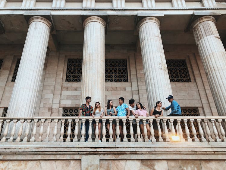 Photo Of Couples Standing Near Railings