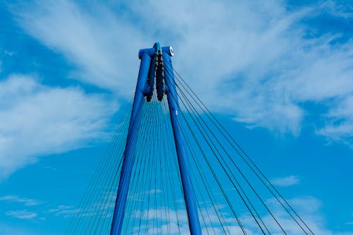 A blue bridge with a blue sky and clouds