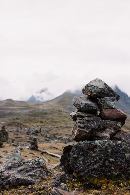 Free A tranquil shot of a stone cairn in the misty mountains of Cusco, Peru. Stock Photo