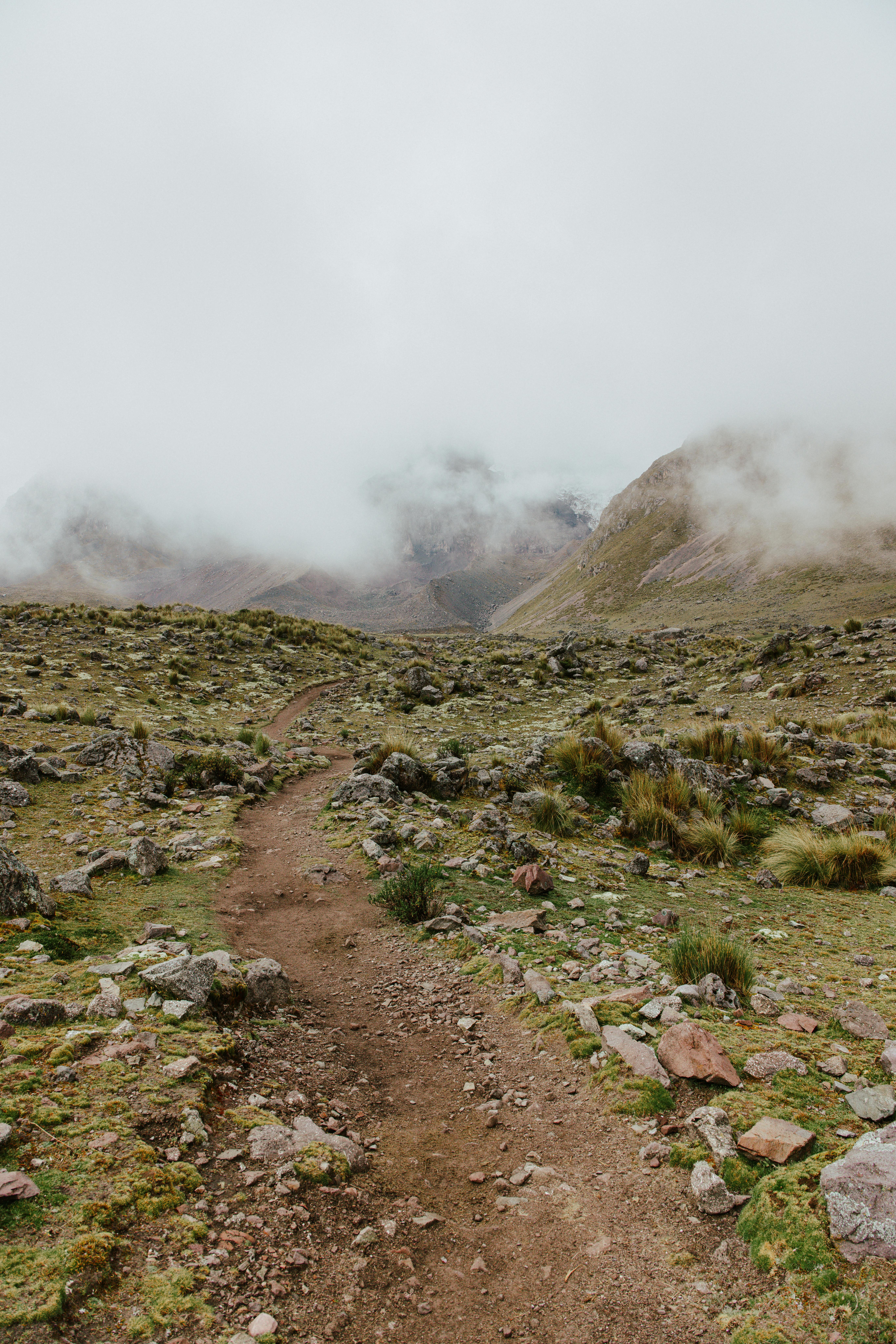 Explore a mist-covered path in the rugged mountains of Cusco, Peru. Ideal for depicting adventure and tranquility.
