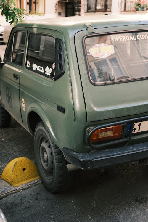 A green car parked on the side of the road