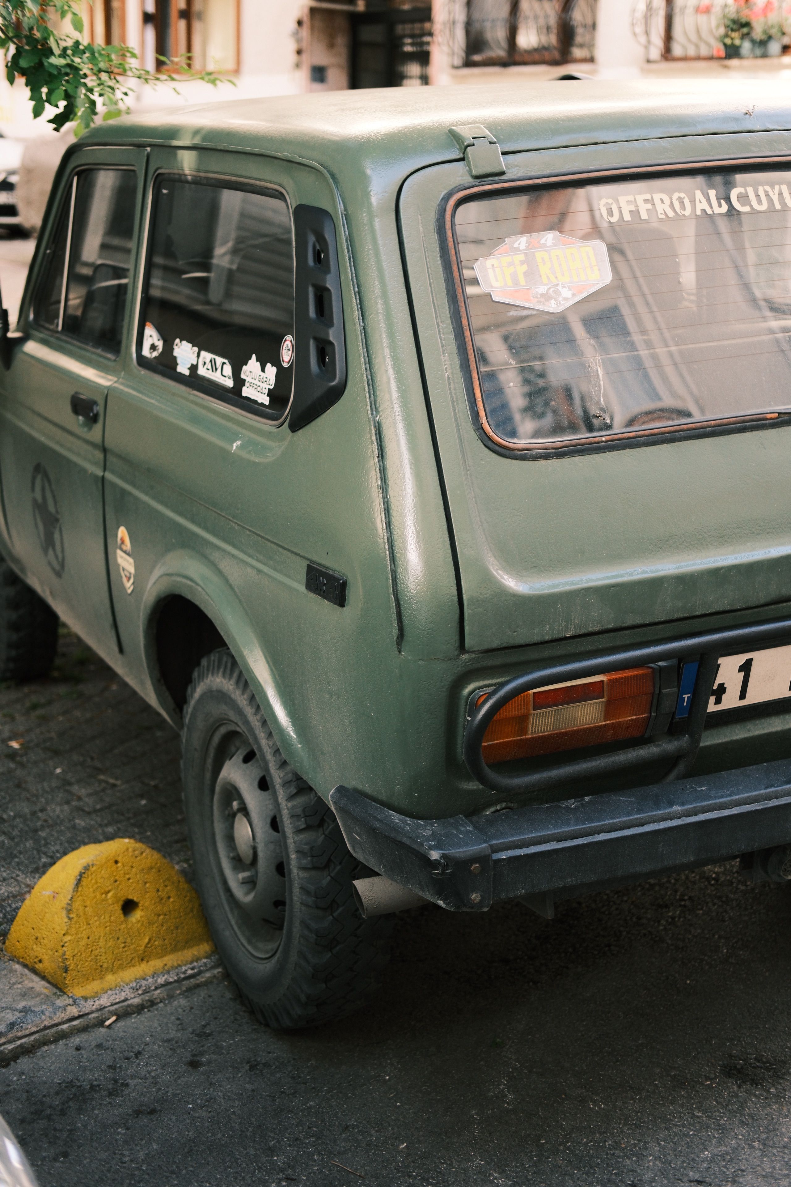 A green car parked on the side of the road · Free Stock Photo