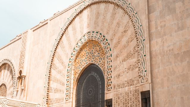 Morocco, Intricate stone facade of Hassan II Mosque in Casablanca, Morocco.