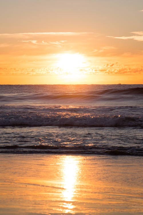 Free Body of Water Under Yellow Sky Stock Photo