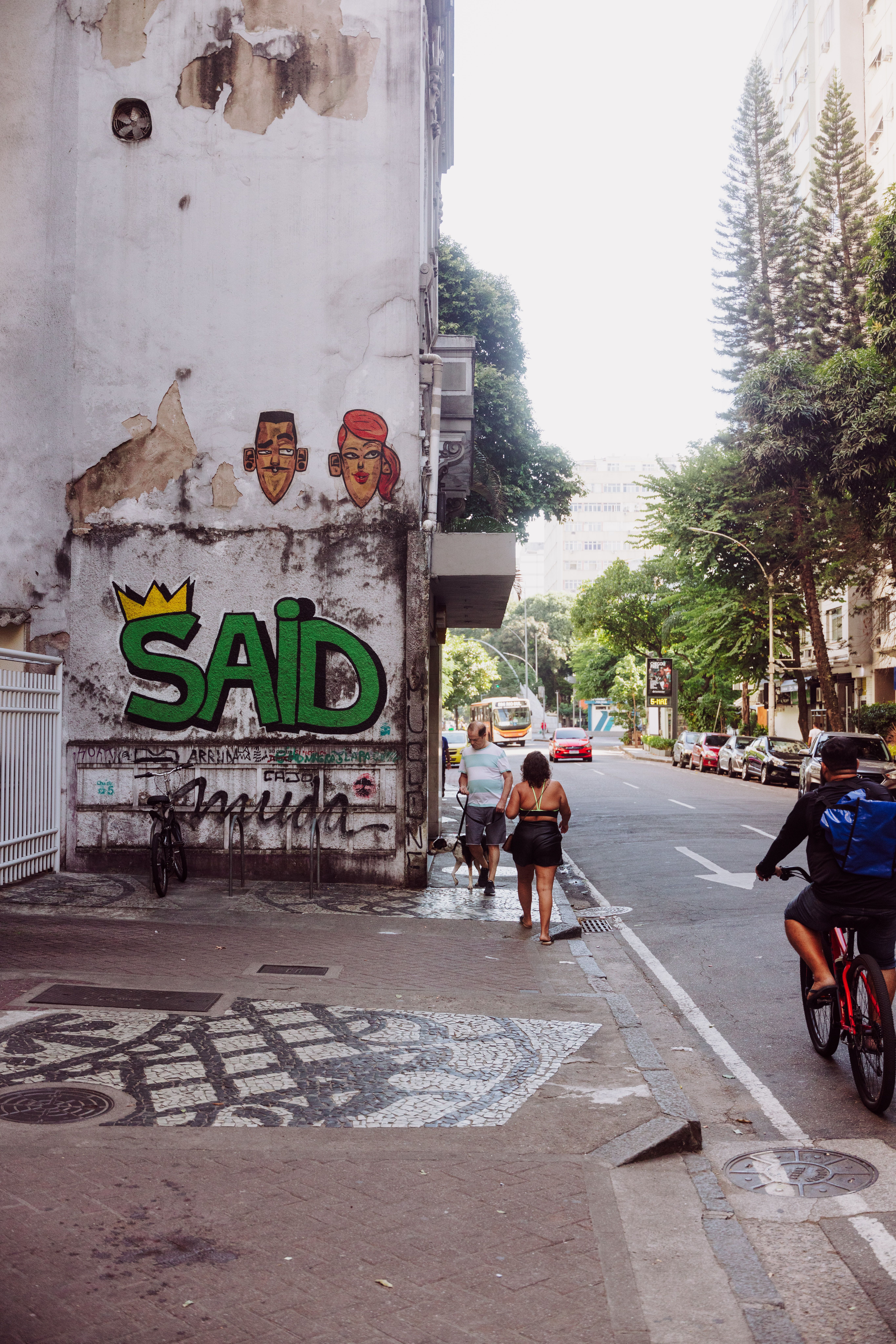A vibrant street scene in Rio de Janeiro with eye-catching graffiti and urban life.