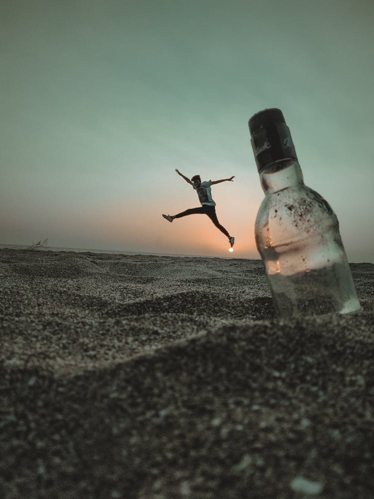 Photo Of Man Jumping On Sand