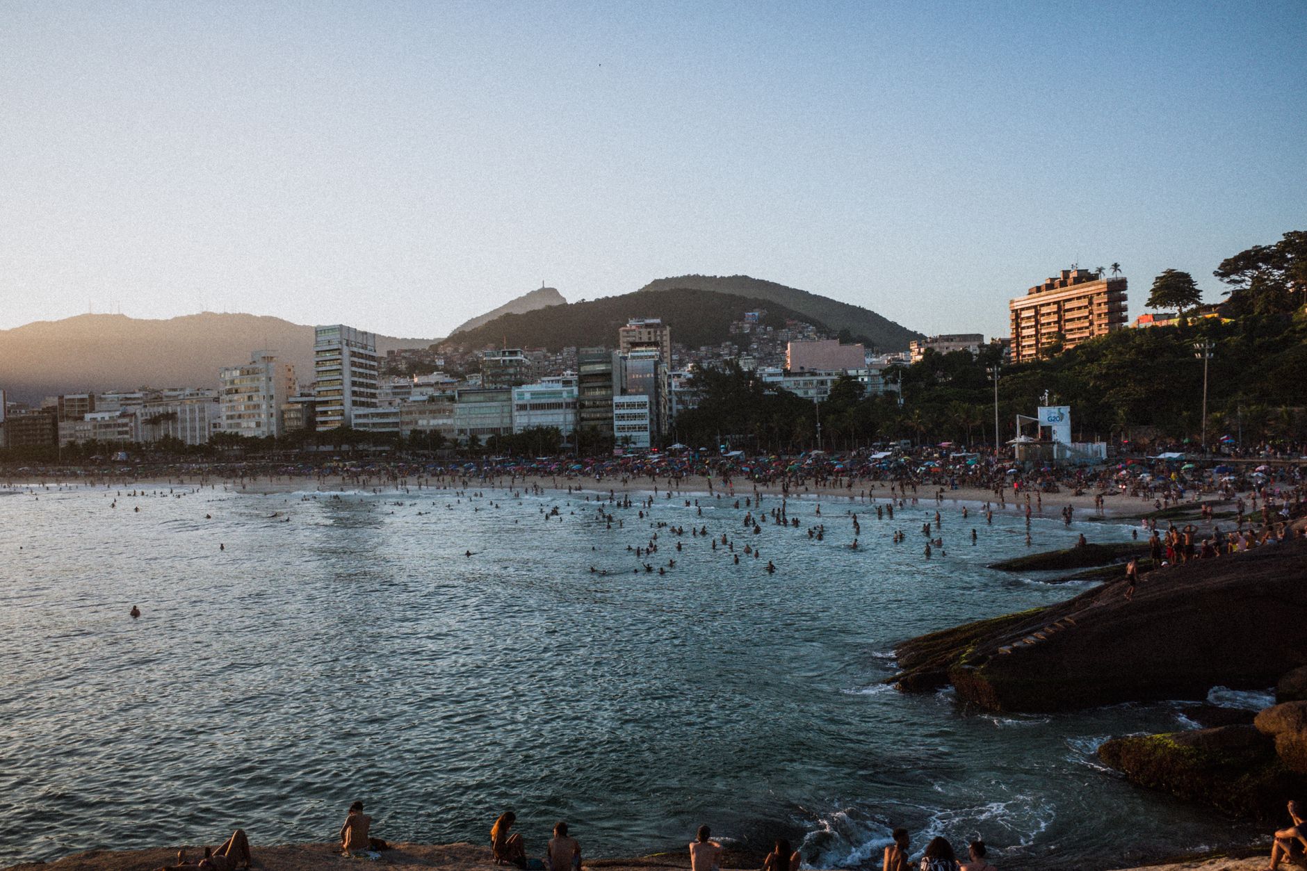 Beautiful sunset at Arpoador Beach in Rio de Janeiro, with a scenic cityscape and vibrant waterfront atmosphere.