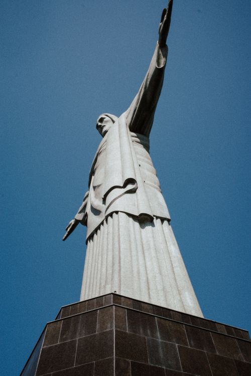 Free Iconic view of Christ the Redeemer statue in Rio de Janeiro against a clear blue sky. Stock Photo