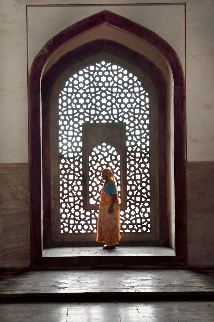 Woman Standing Near Mosaic Window