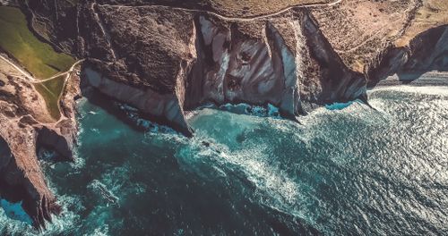 Free Scenic aerial view of Zumaya's dramatic cliffs and vibrant ocean waters. Stock Photo