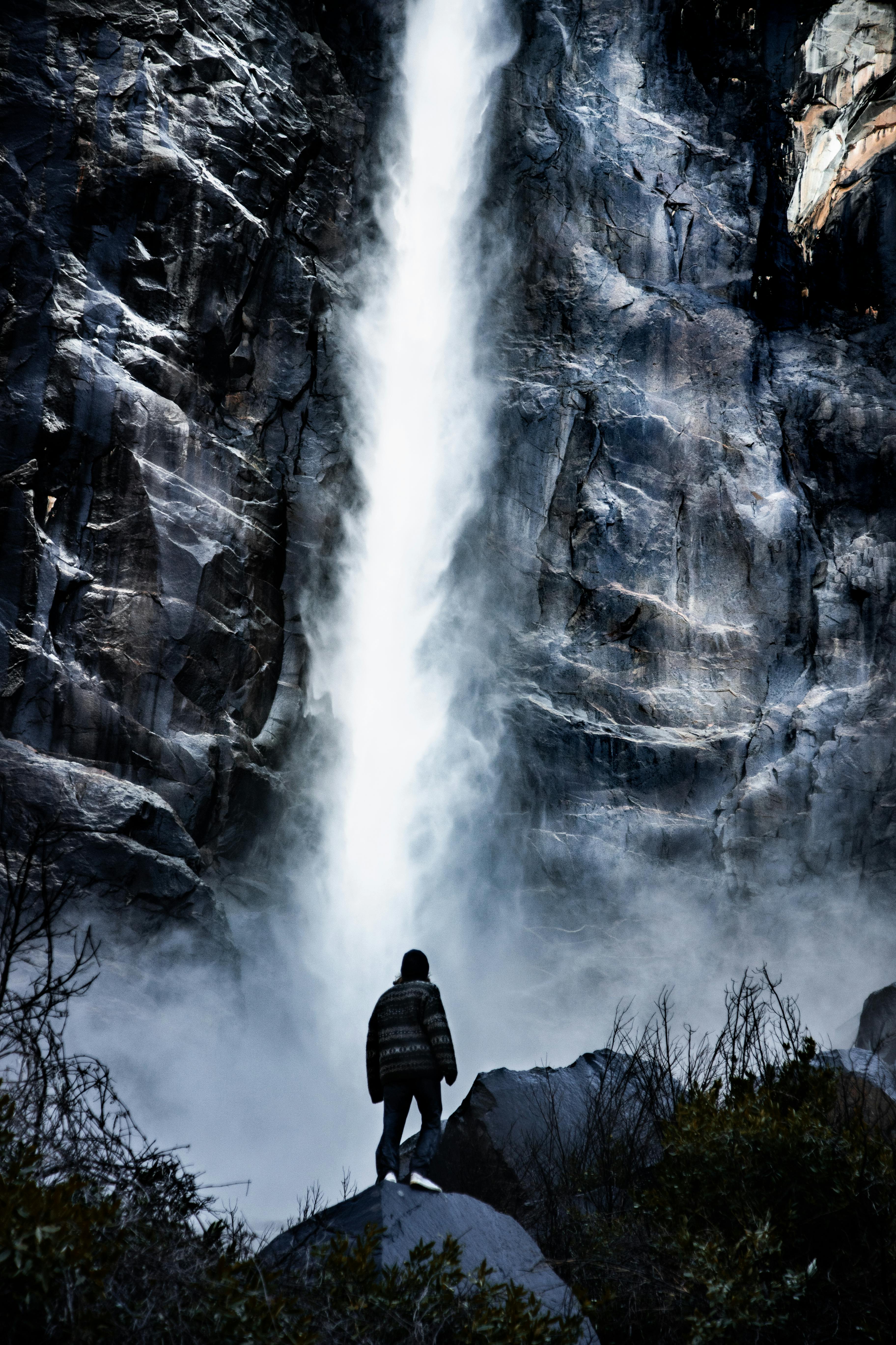 Man standing near a waterfall · Free Stock Photo